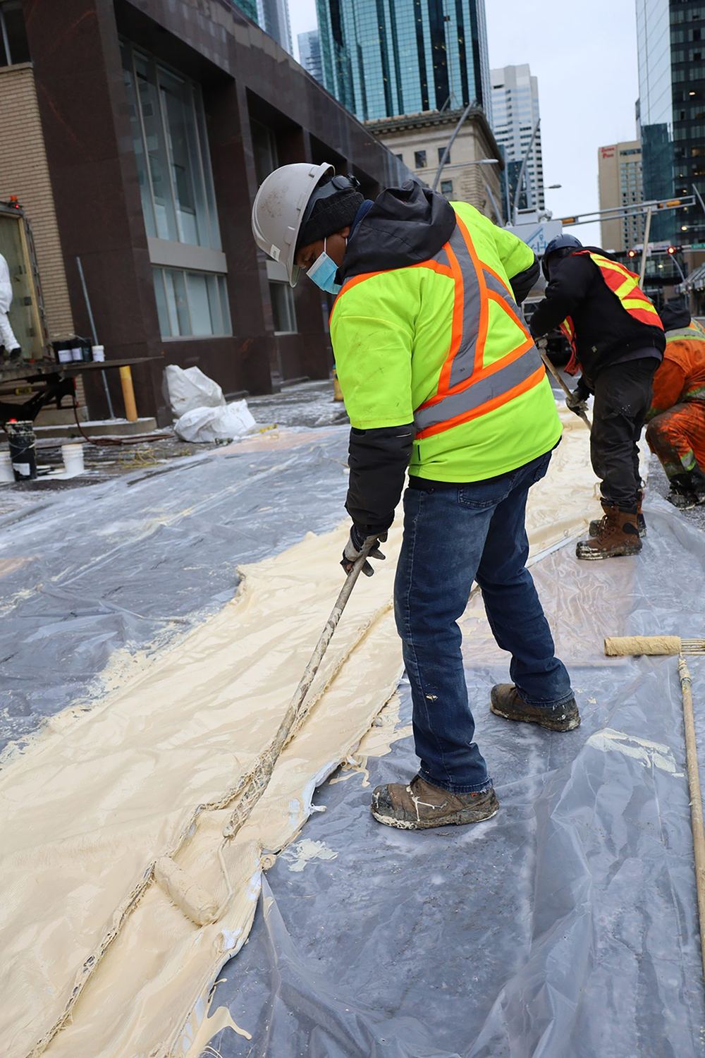 A crew saturating a liner on site